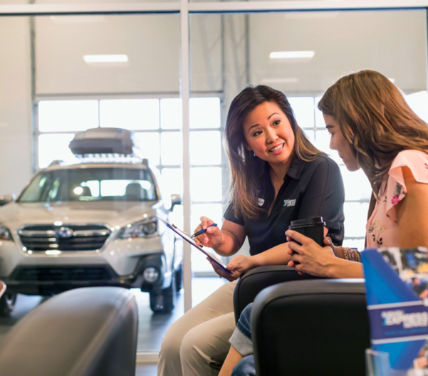 Subaru service technician speaking with a customer