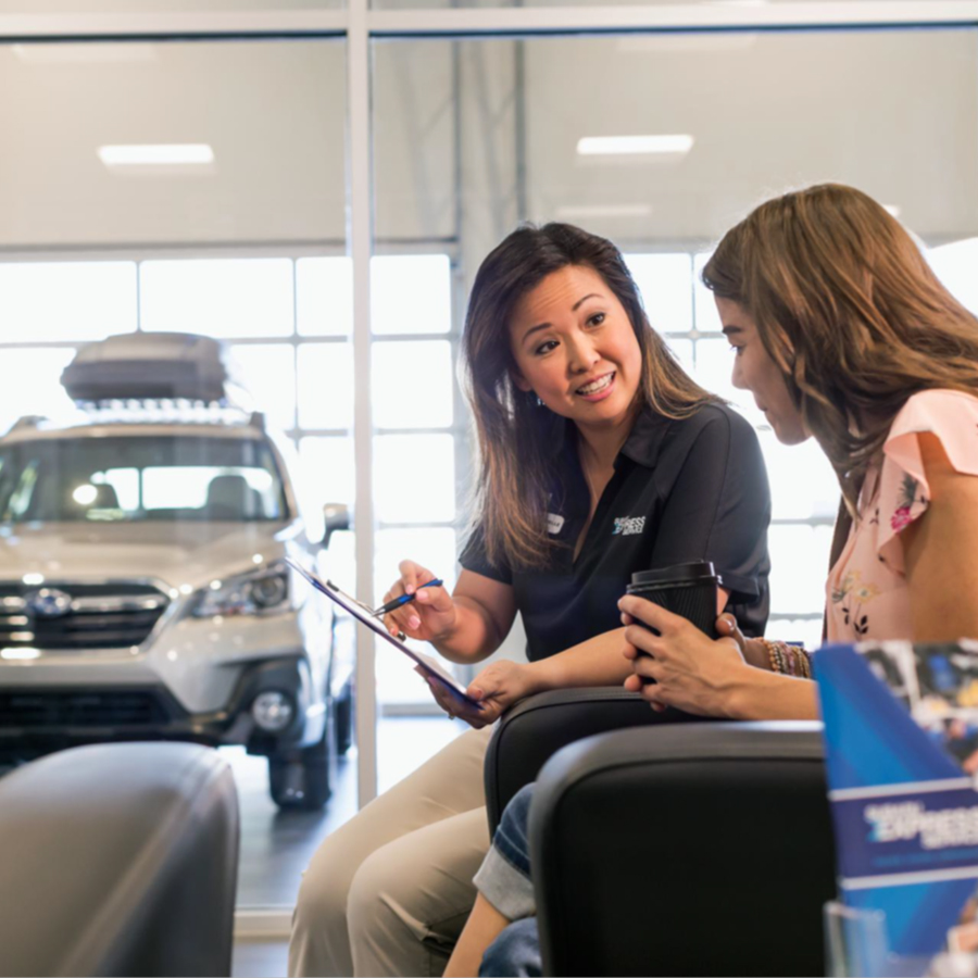 Subaru sales person talking to customer