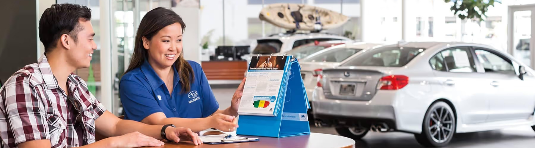 Subaru sales person talking to customer