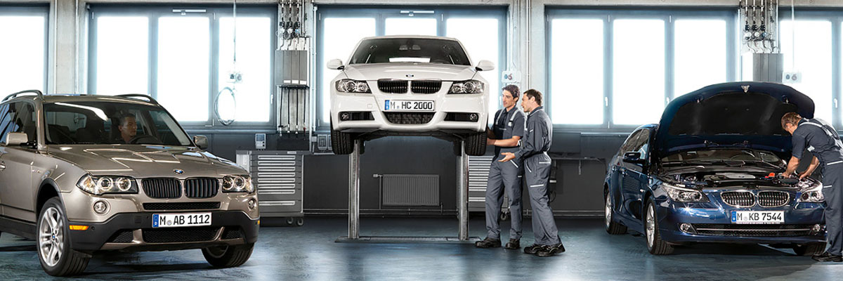 BMW vehicles being repaired by BMW mechanics
