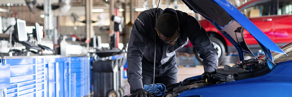 Chevy mechanic looking under the hood