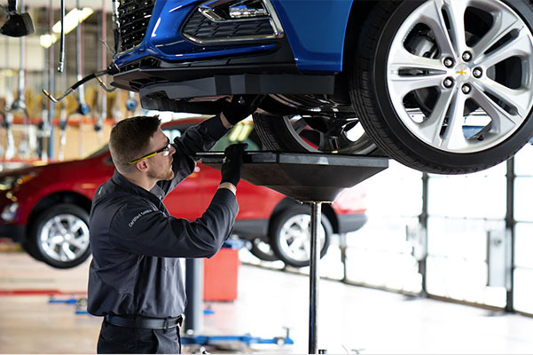 Chevy mechanic doing an oil change