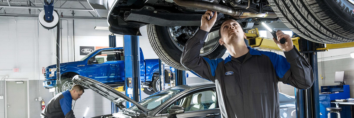 Ford mechanics working on vehicles