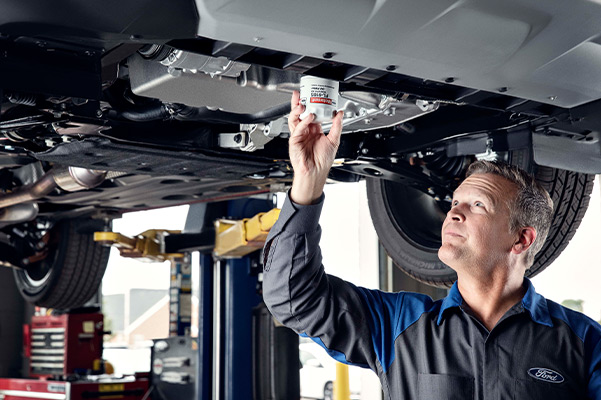 Ford mechanic checking under a vehicle