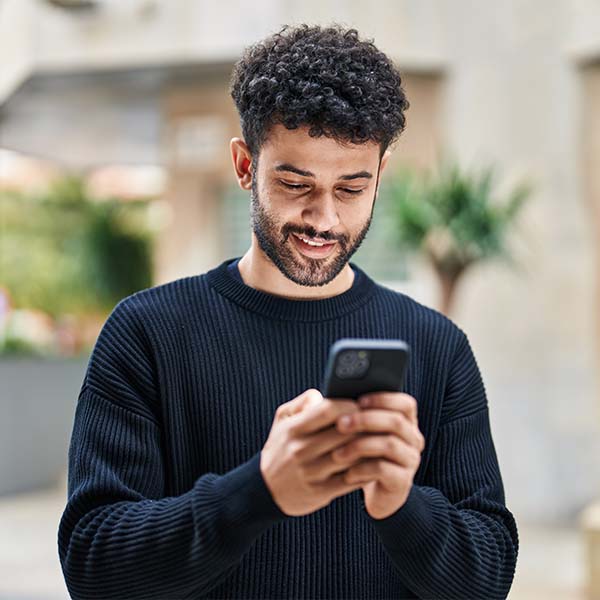 Up close shot of man using smartphone to track Lincoln Pickup & Delivery services