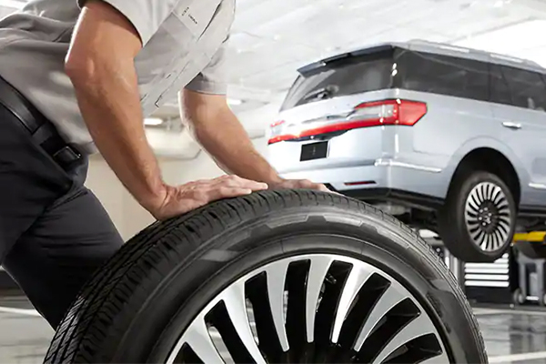 Lincoln mechanic replacing tires