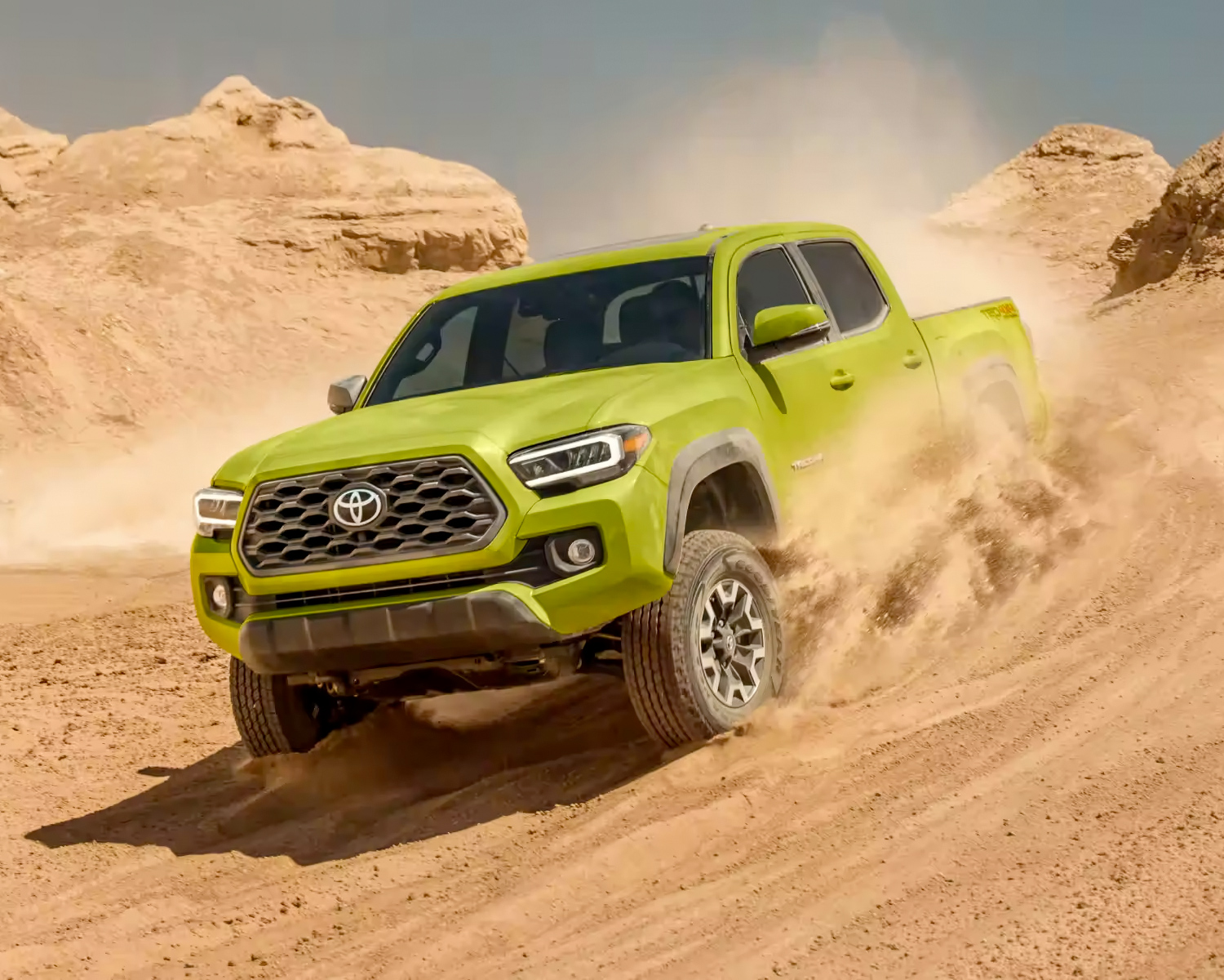 Exterior shot of a toyota driving in a desert.