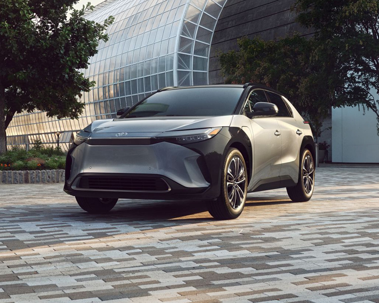 New Toyota bZ4X parked in front of a scenic downtown building