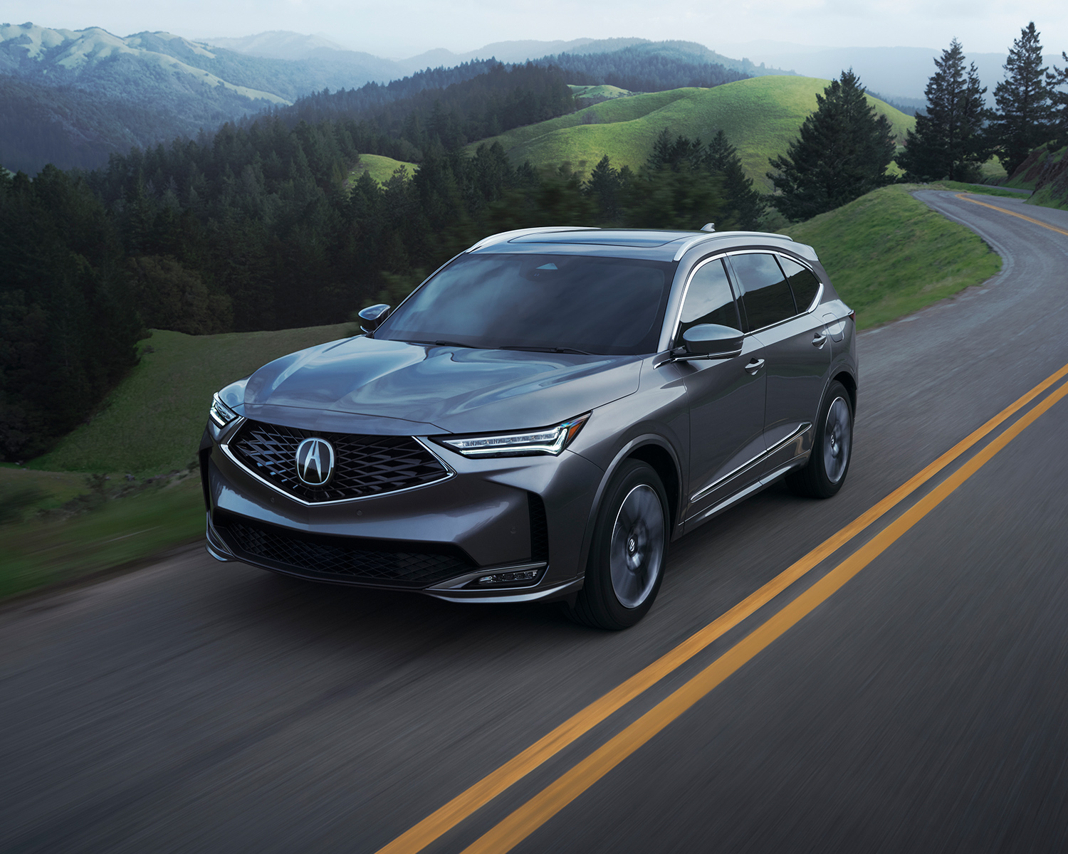 2025 Acura MDX driving on mountain highway