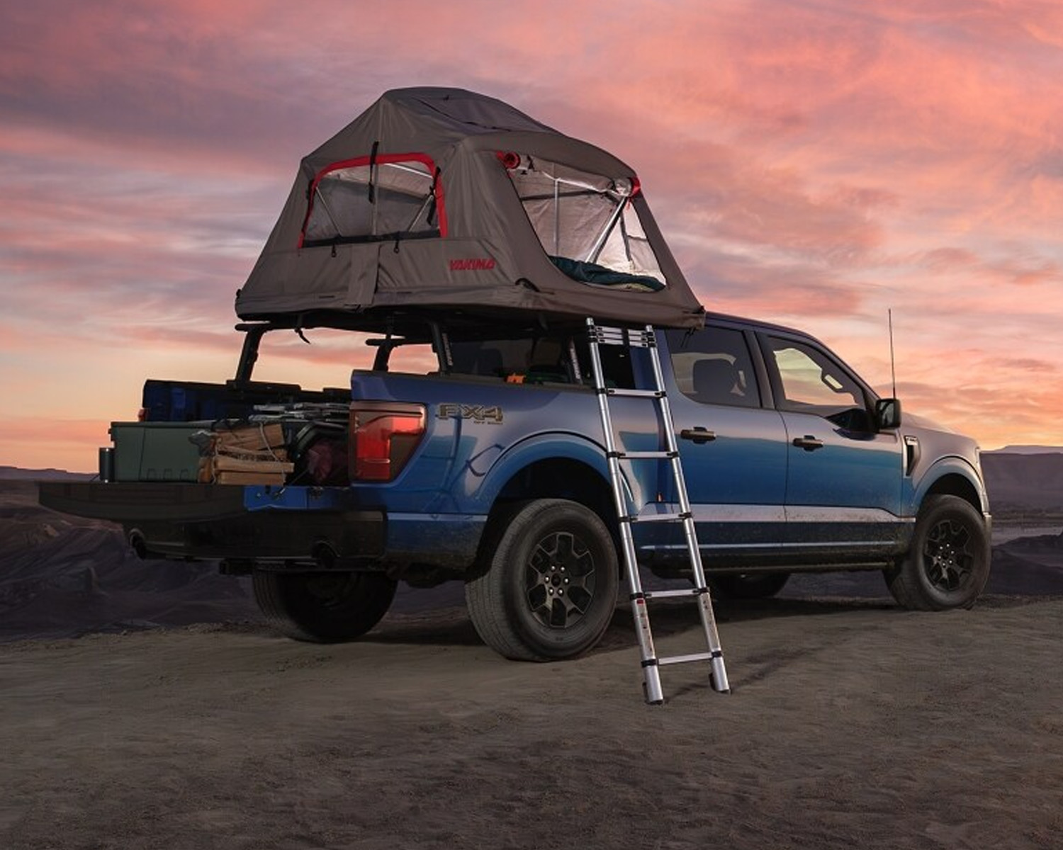 Blue 2025 Ford F-150 with camping equiptment in bed.