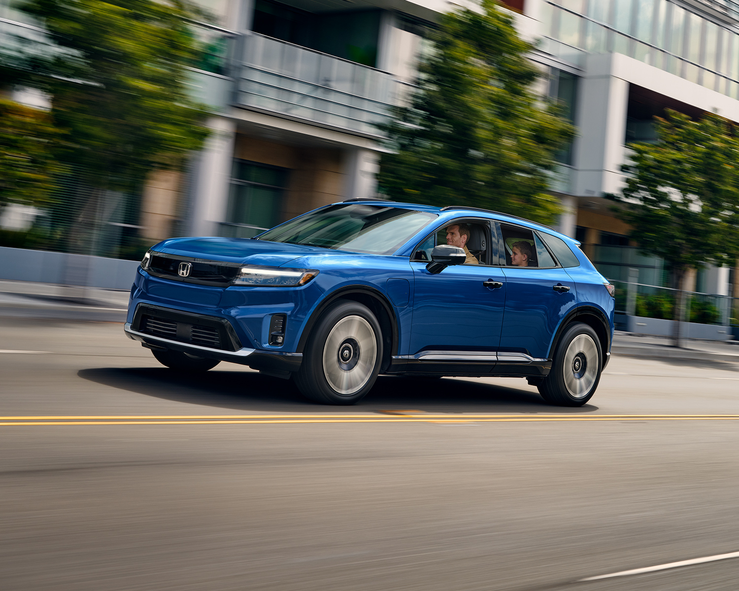 2025 Honda Prologue driving down a city street