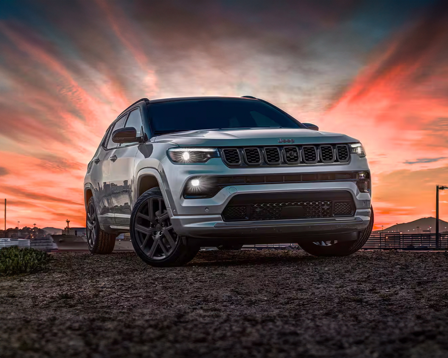 2025 Jeep Compass pictured in front of a dramatic sunrise