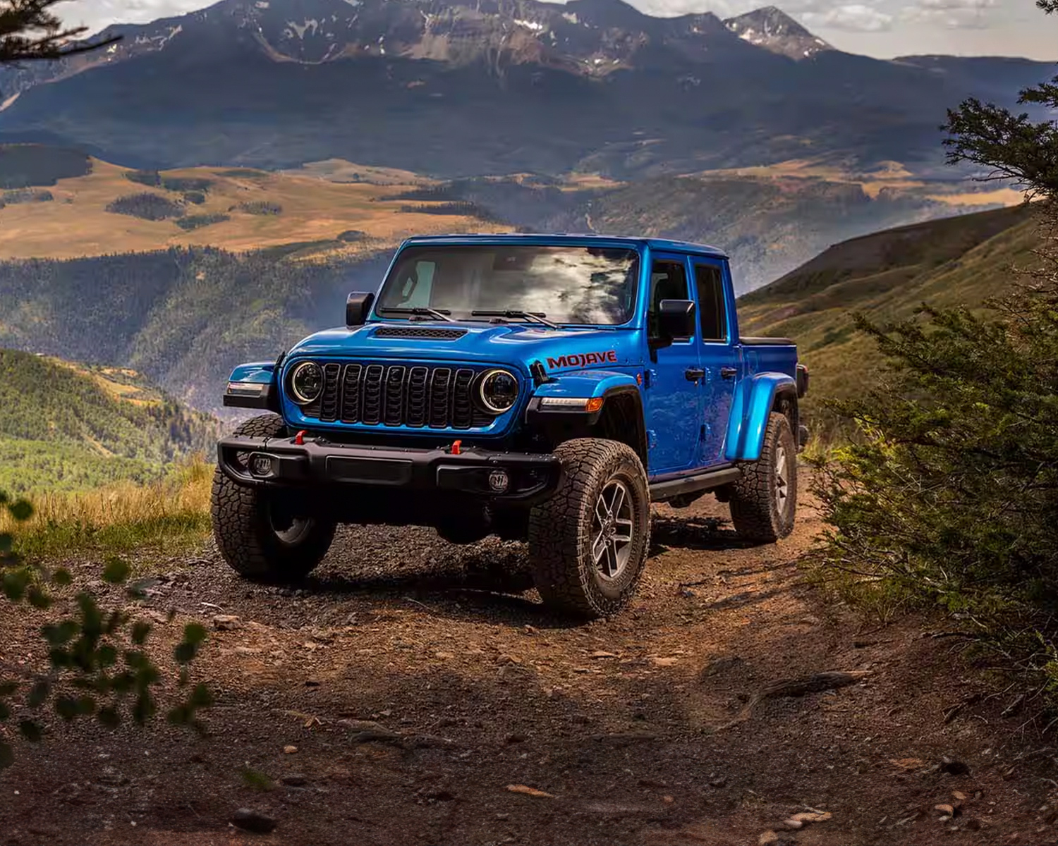 Action shot of a 2025 Gladiator off-roading through mountains