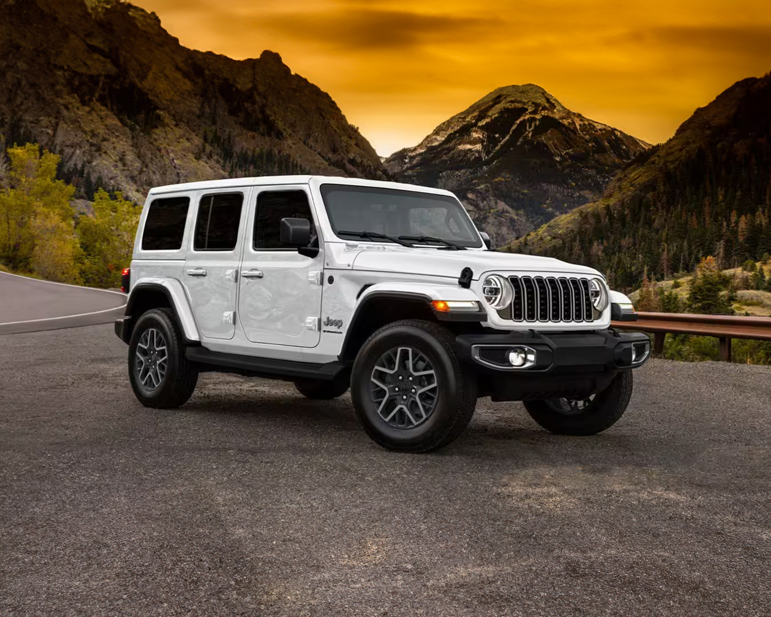 2025 Jeep Wrangler parked in front of mountains while the sun is setting