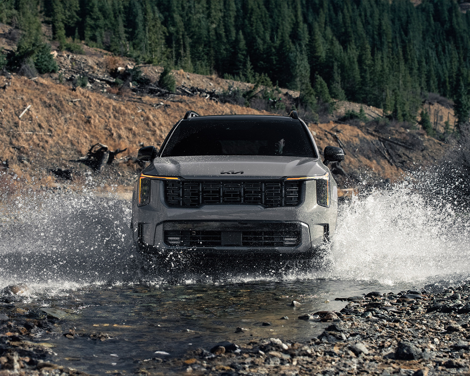 Front view of 2025 Kia Sorento driving through shallow body of water