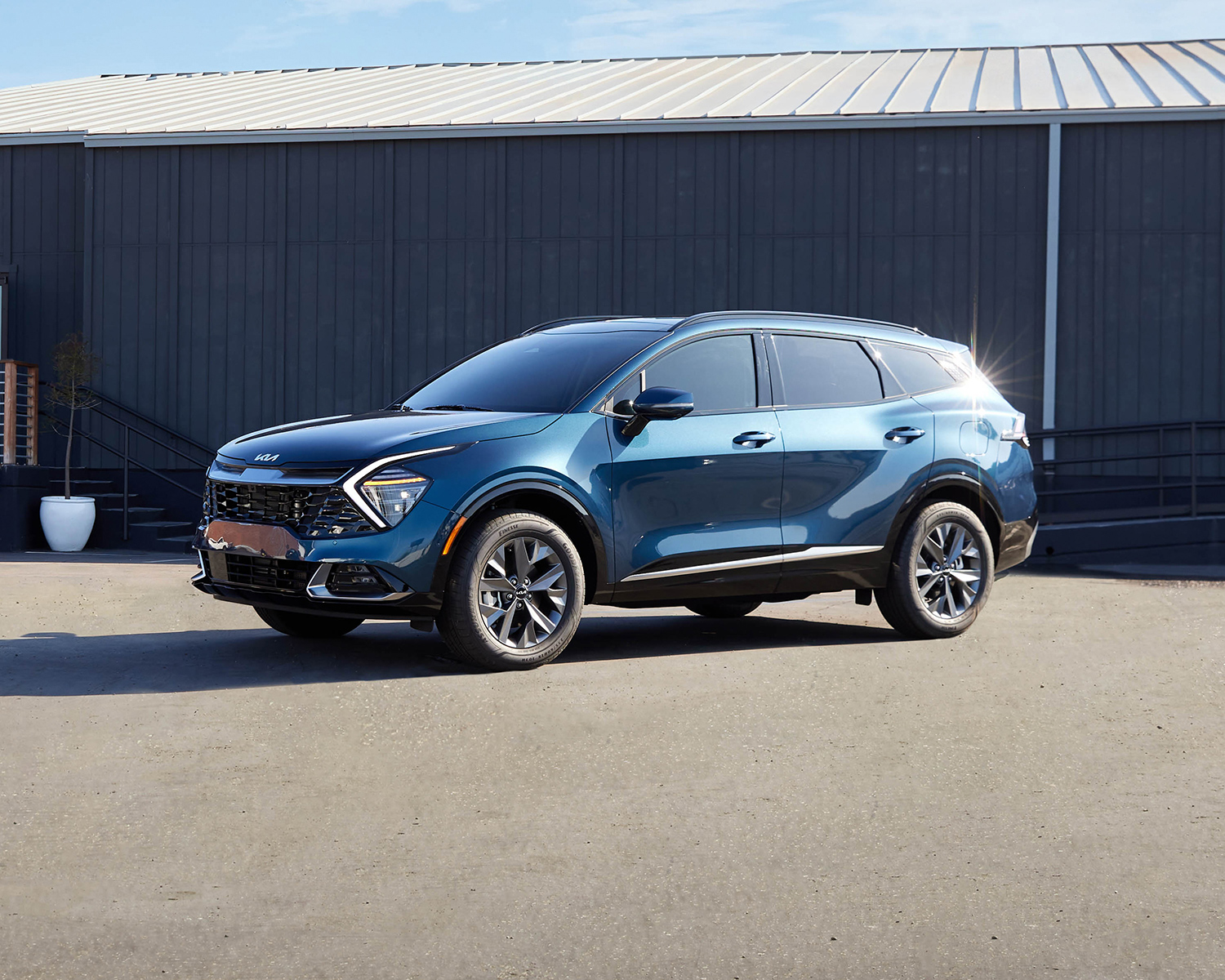 2025 Kia Sportage parked in front of a warehouse