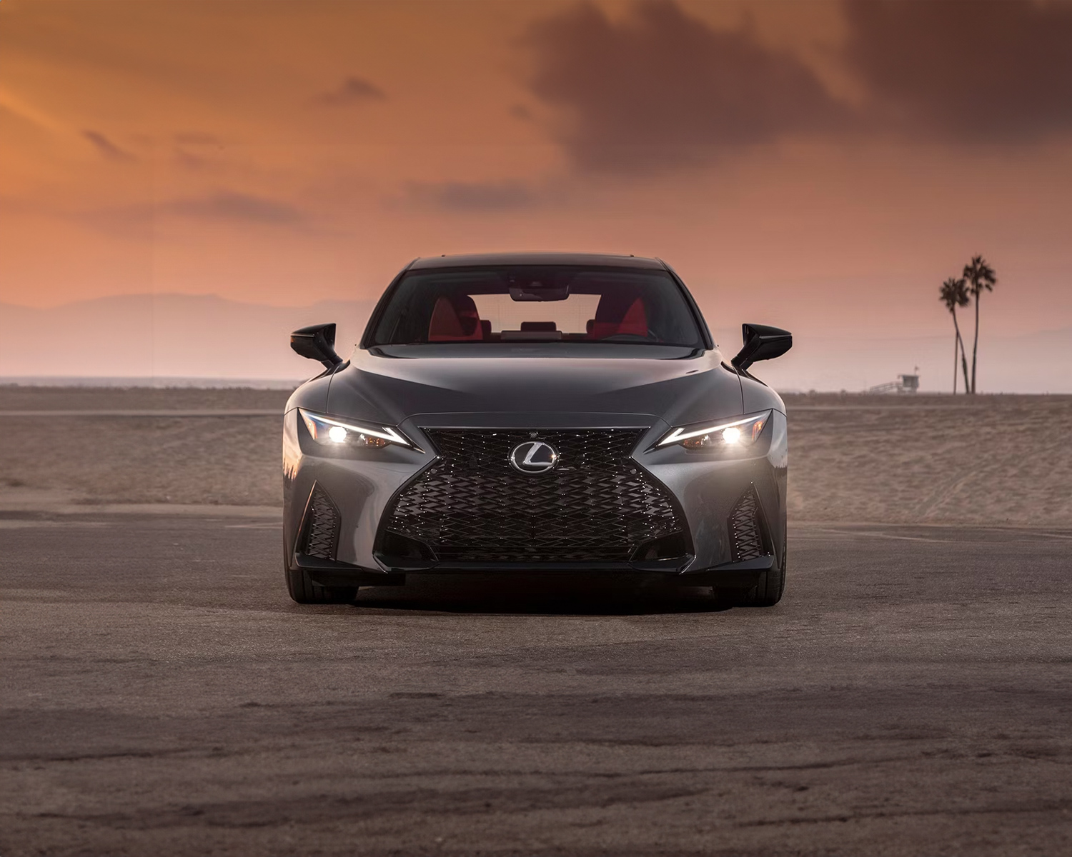 2025 Lexus IS parked in front of a sunset