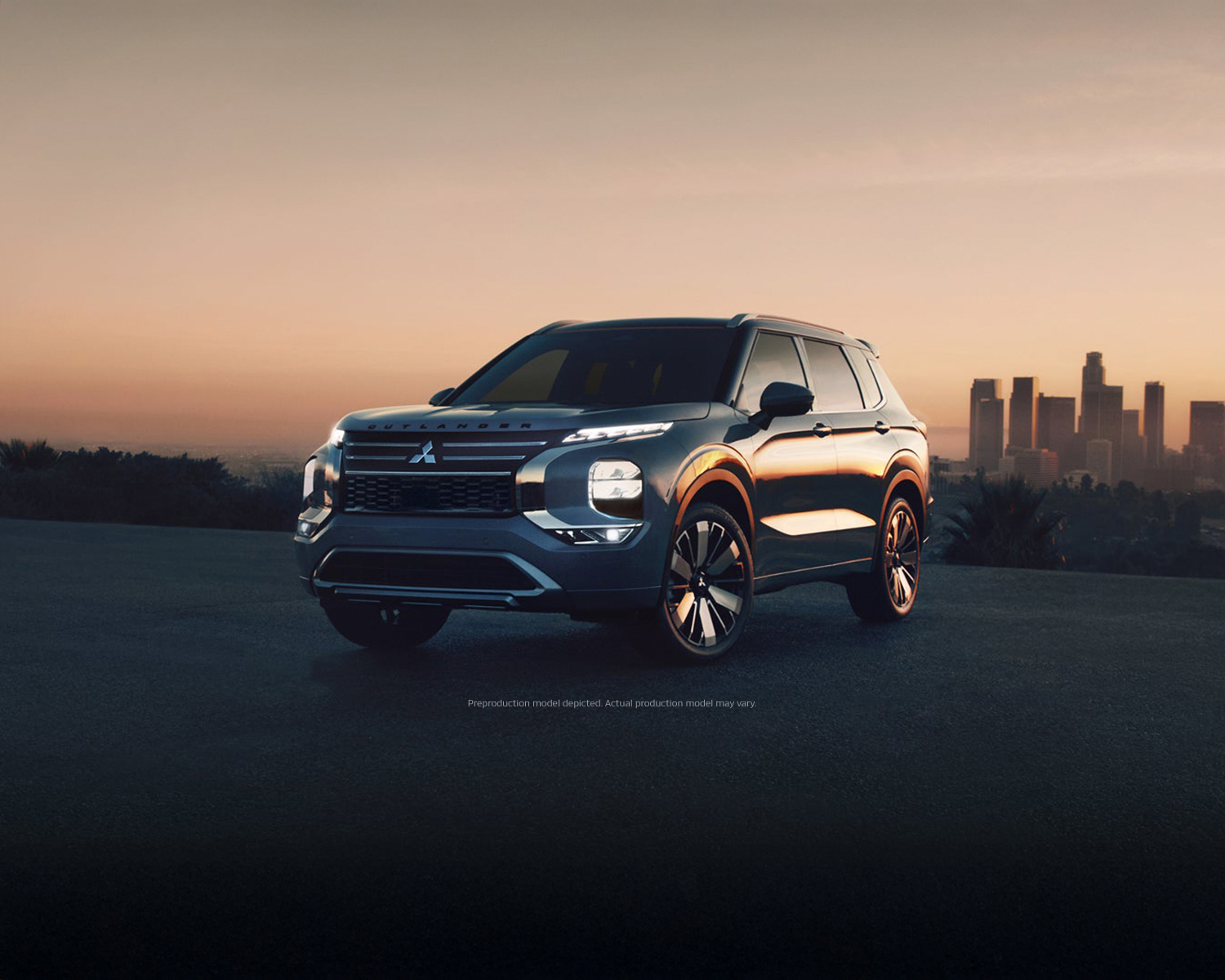 3/4 view of a 2025 Mitsubishi Outlander parked with city view in the background