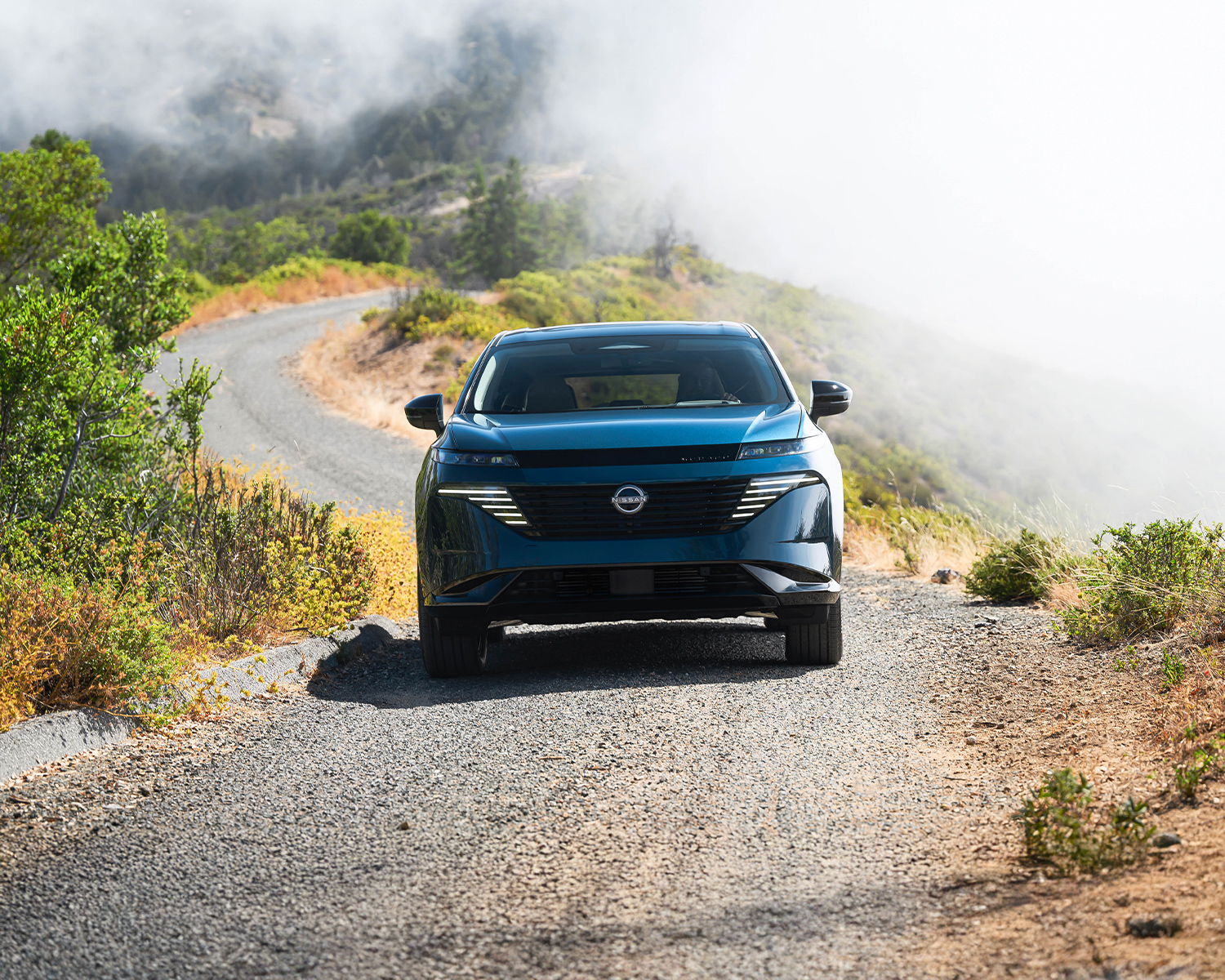Action shot of the 2025 Nissan Murano driving through the mountains