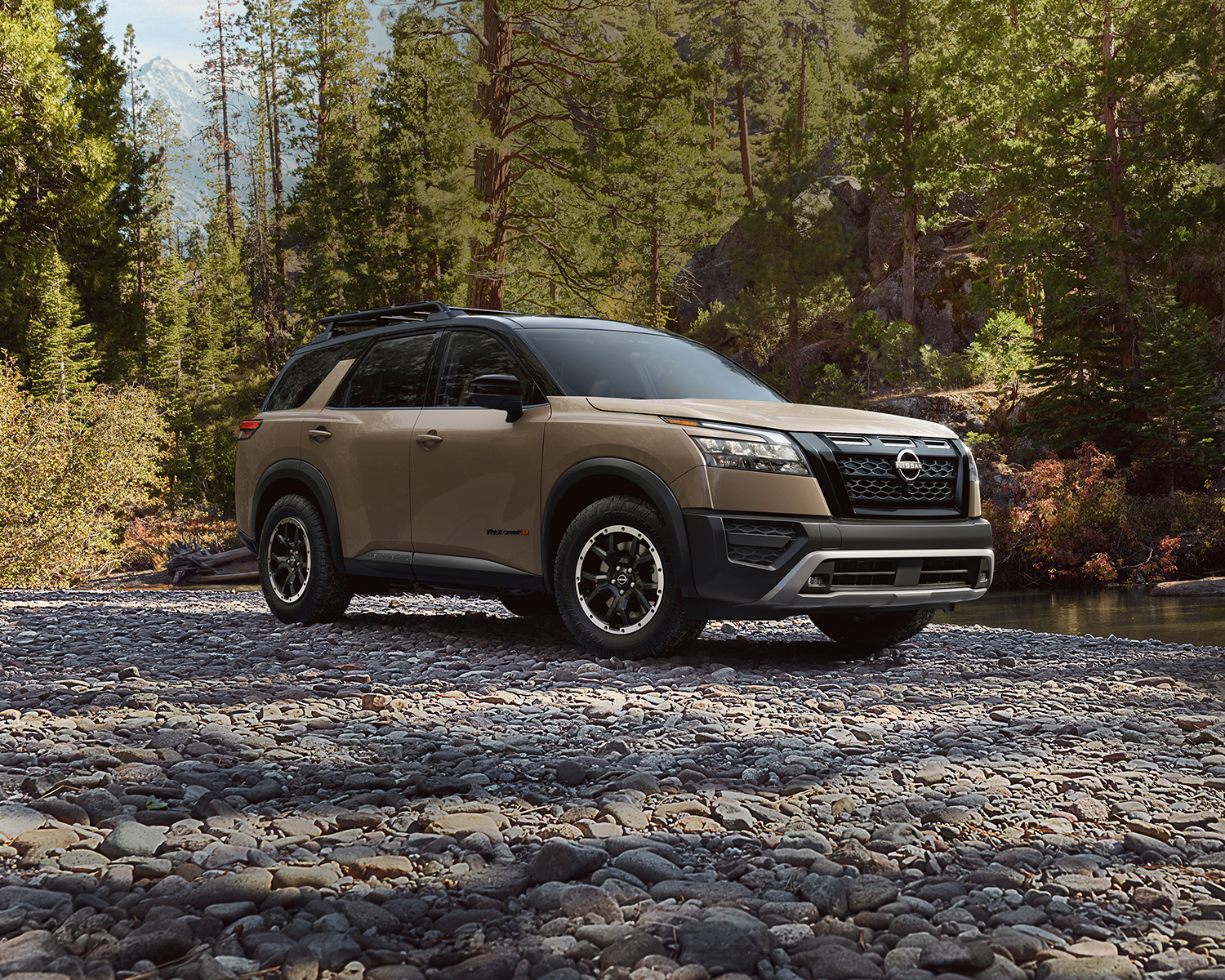 2025 Nissan Pathfinder on a street surrounded by pine trees