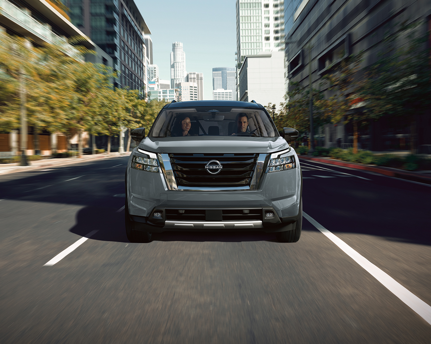 2025 Nissan Pathfinder driving down a city road