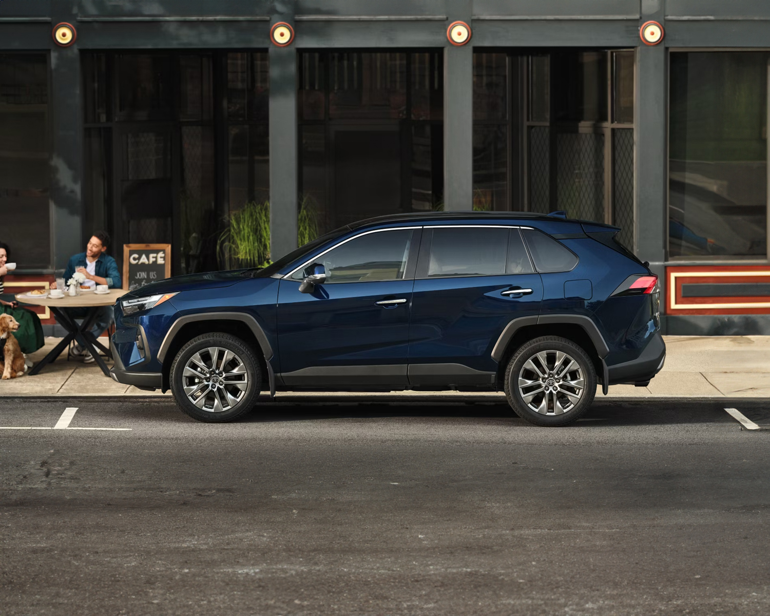 2025 Toyota RAV4 parked in front of a modern restaurant