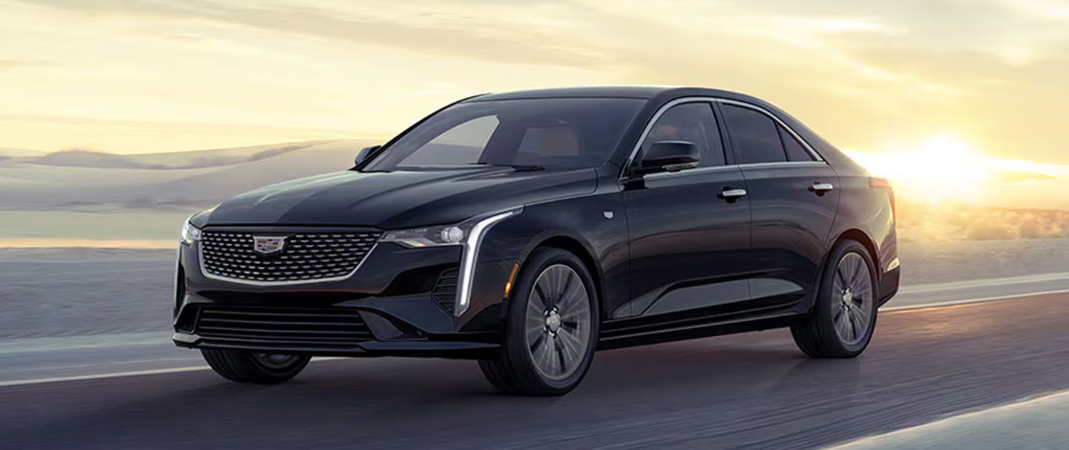 Cadillac CT4 driving on a road during sunset
