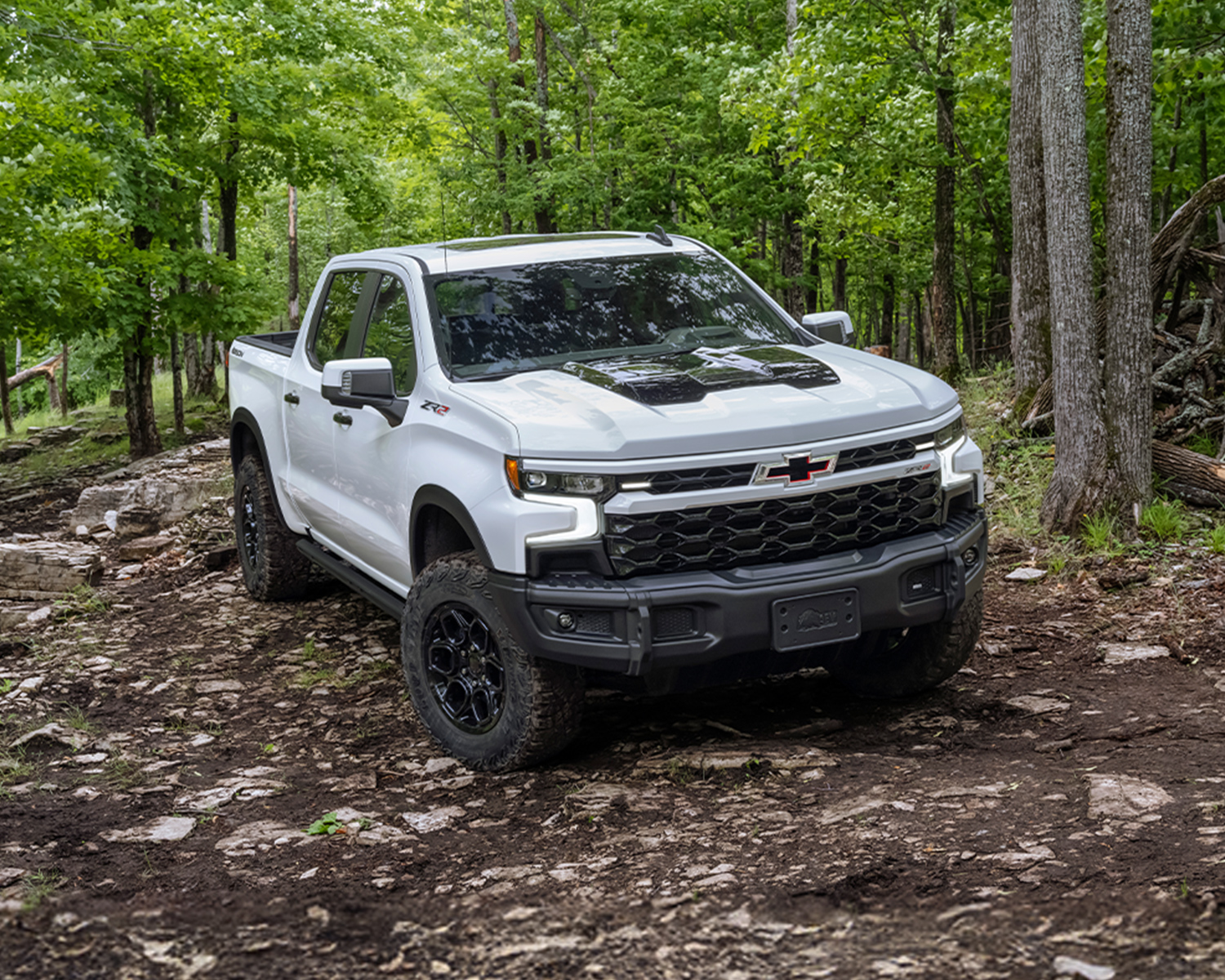 2026 Chevrolet Silverado LD driving through a forest.