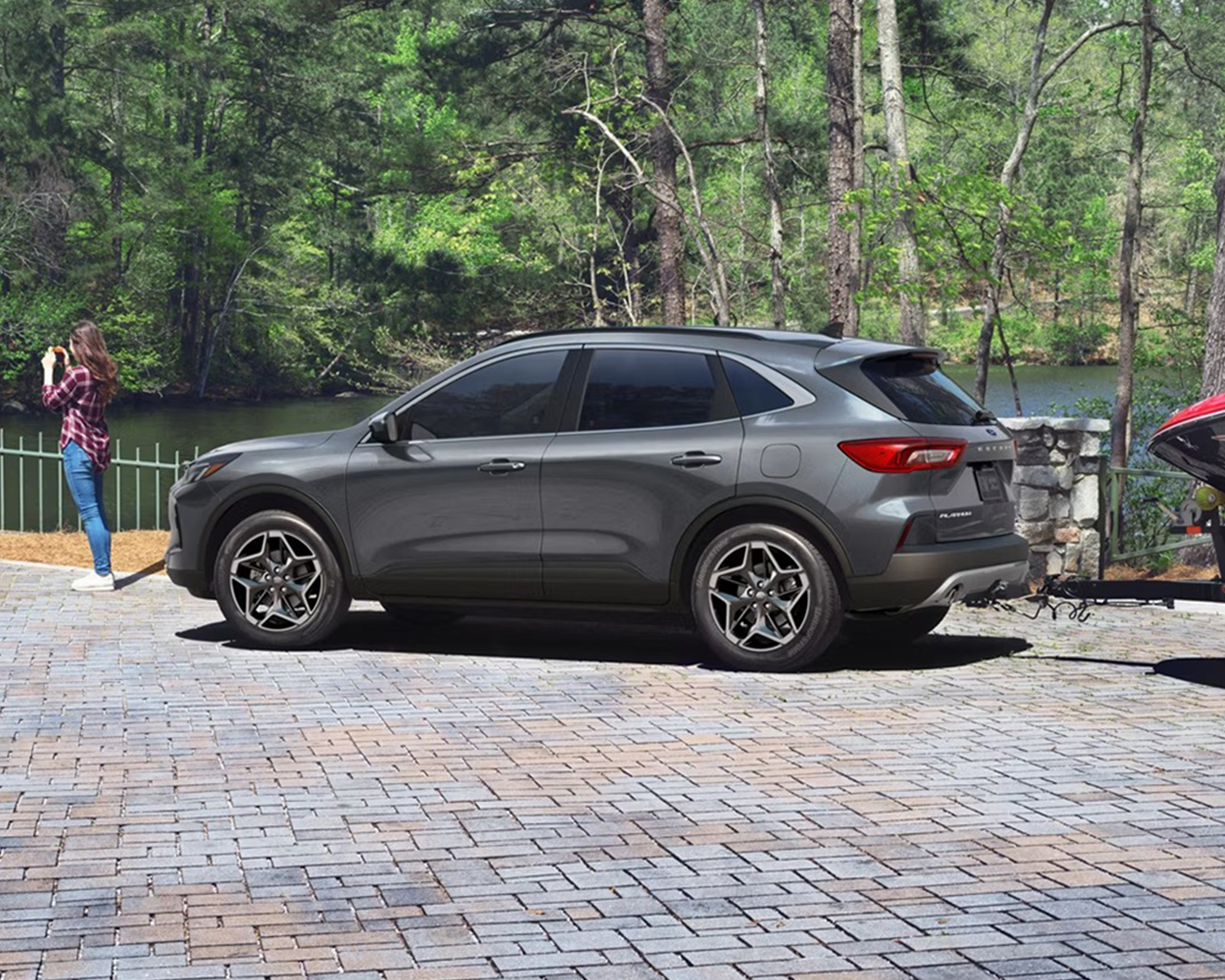 Family taking pictures parked next to their new Ford SUV