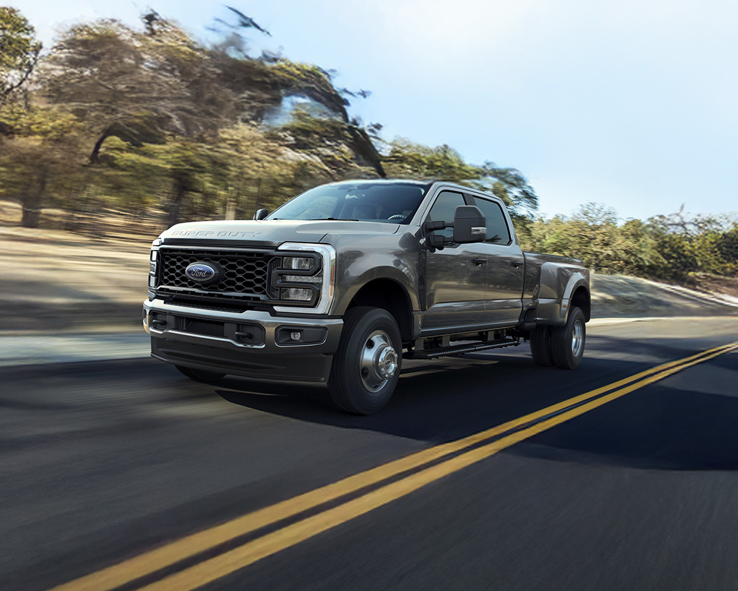 2026 Ford Super Duty driving down a rural road