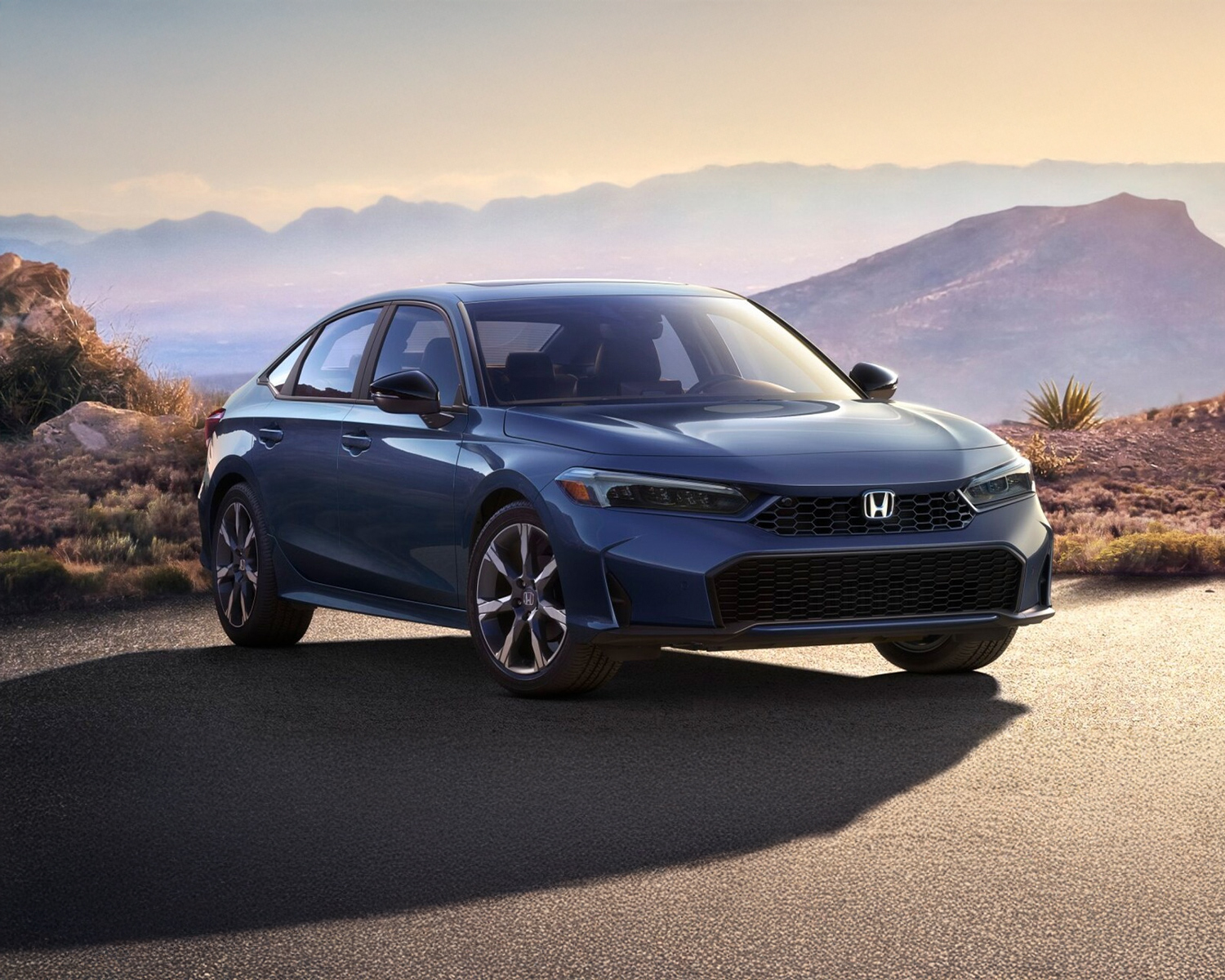 Honda Civic parked with mountains in the background