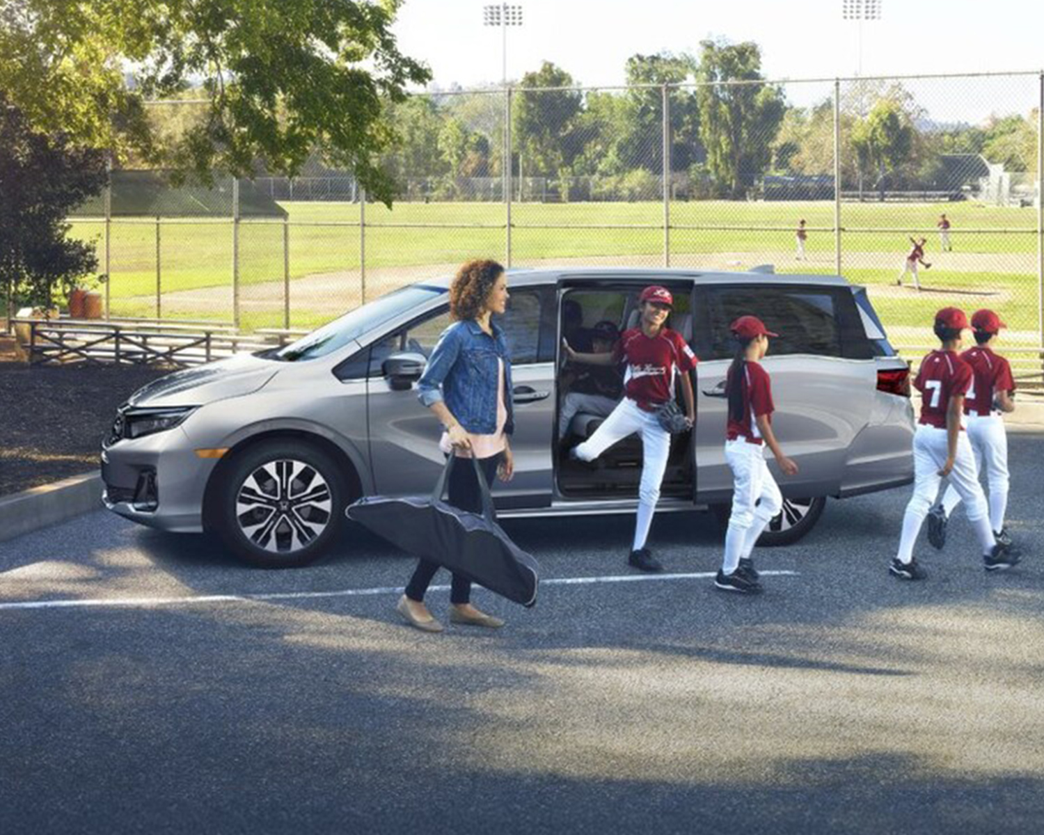 Honda Odyssey parked outside a baseball field