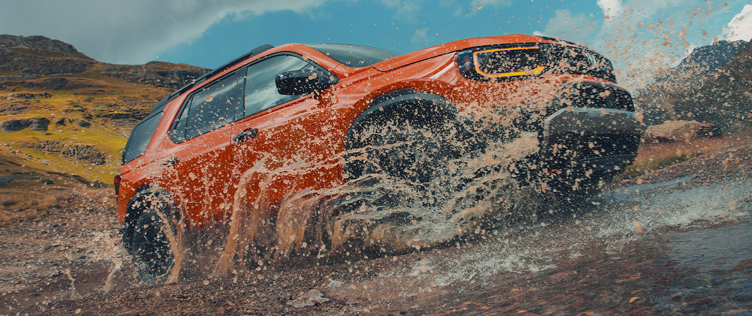 2026 Honda Passport driving offroad kicking up water