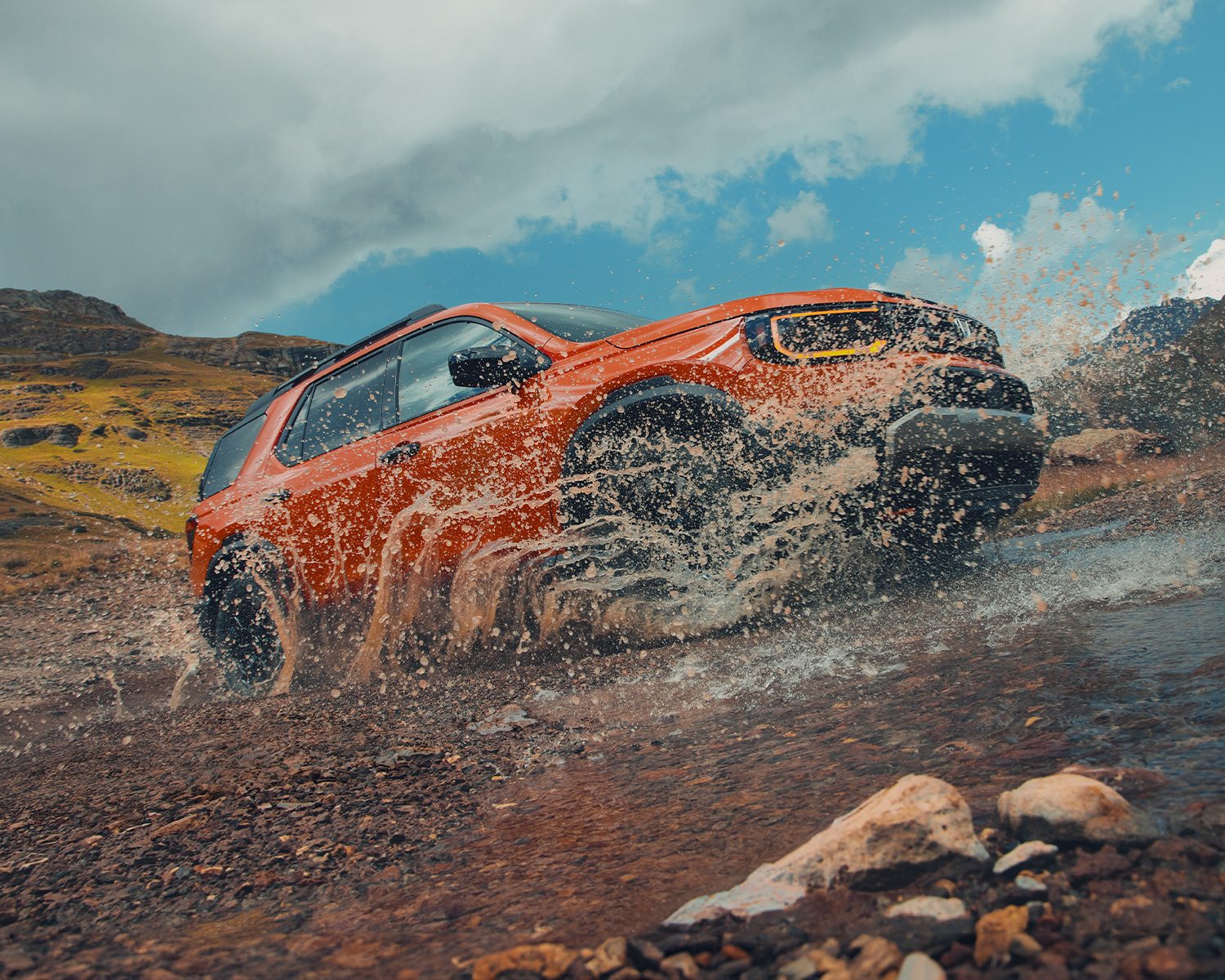 2026 Honda Passport driving through mud.