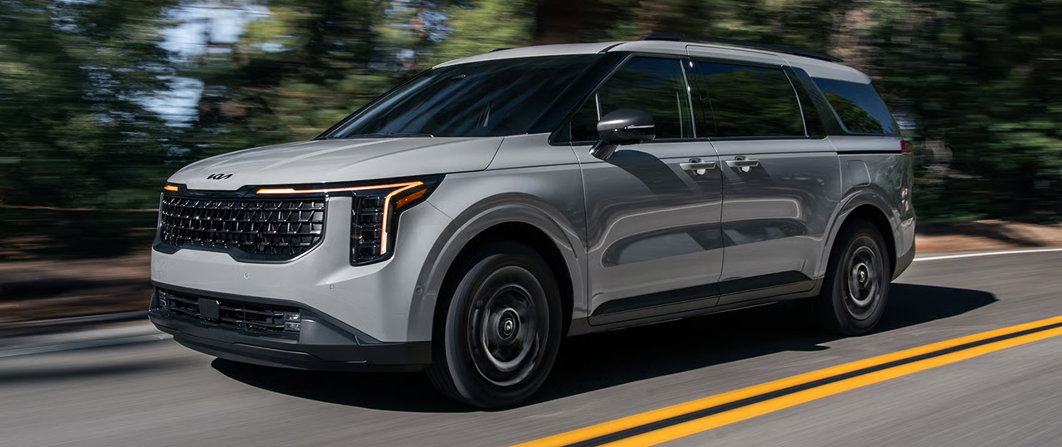 Kia Carnival driving down the road