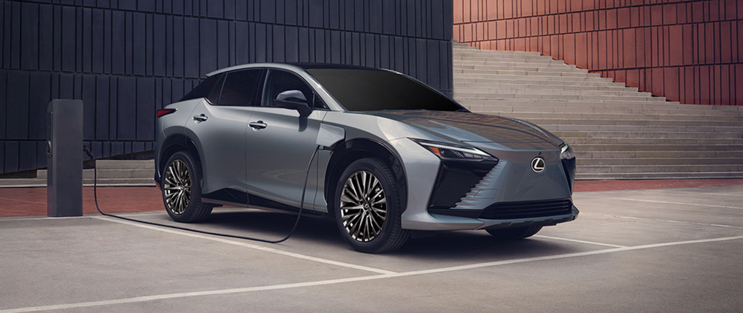 2026 Lexus RZ charging outside a modern building