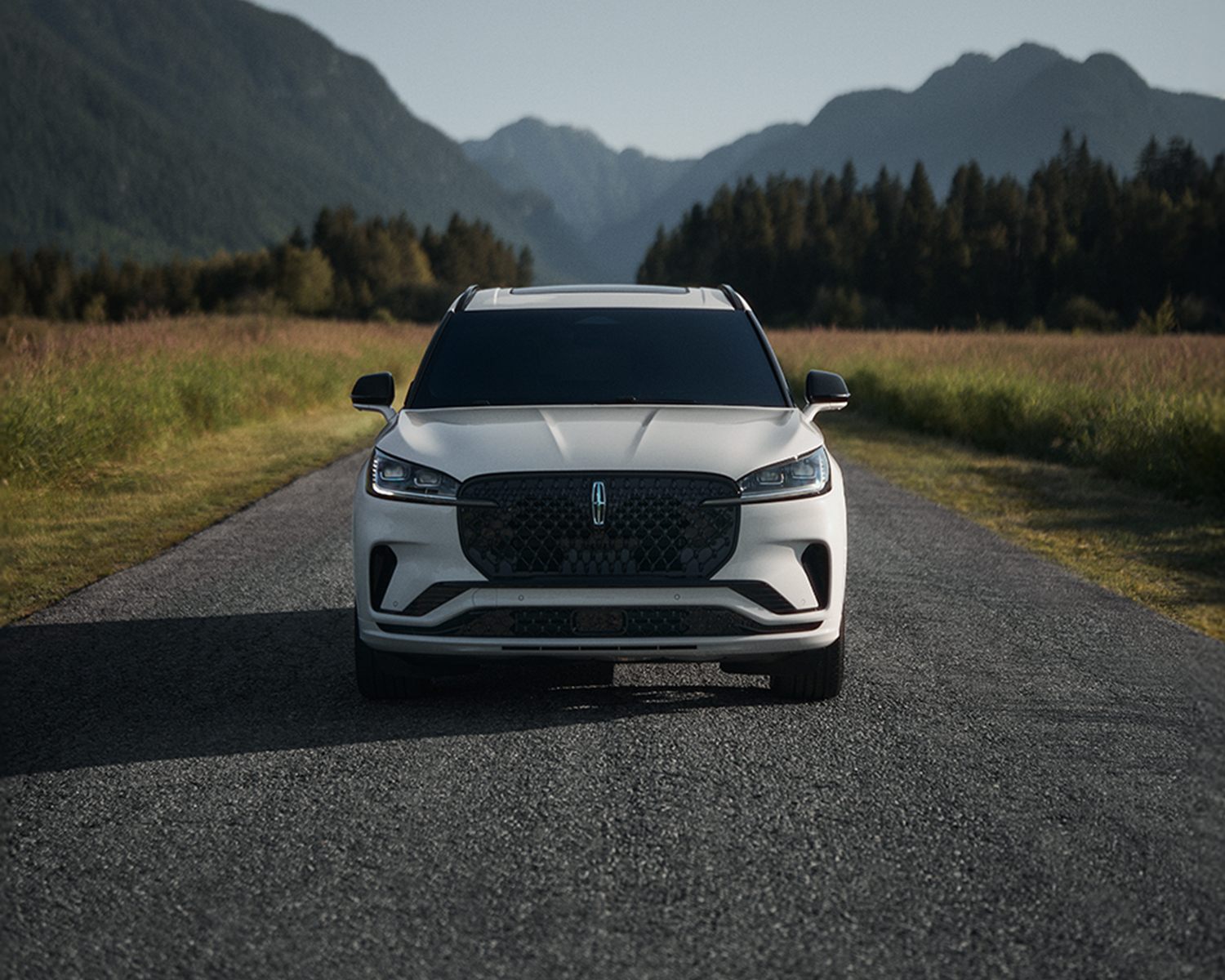 2026 Lincoln Aviator parked on a road surrounded by mountains and trees