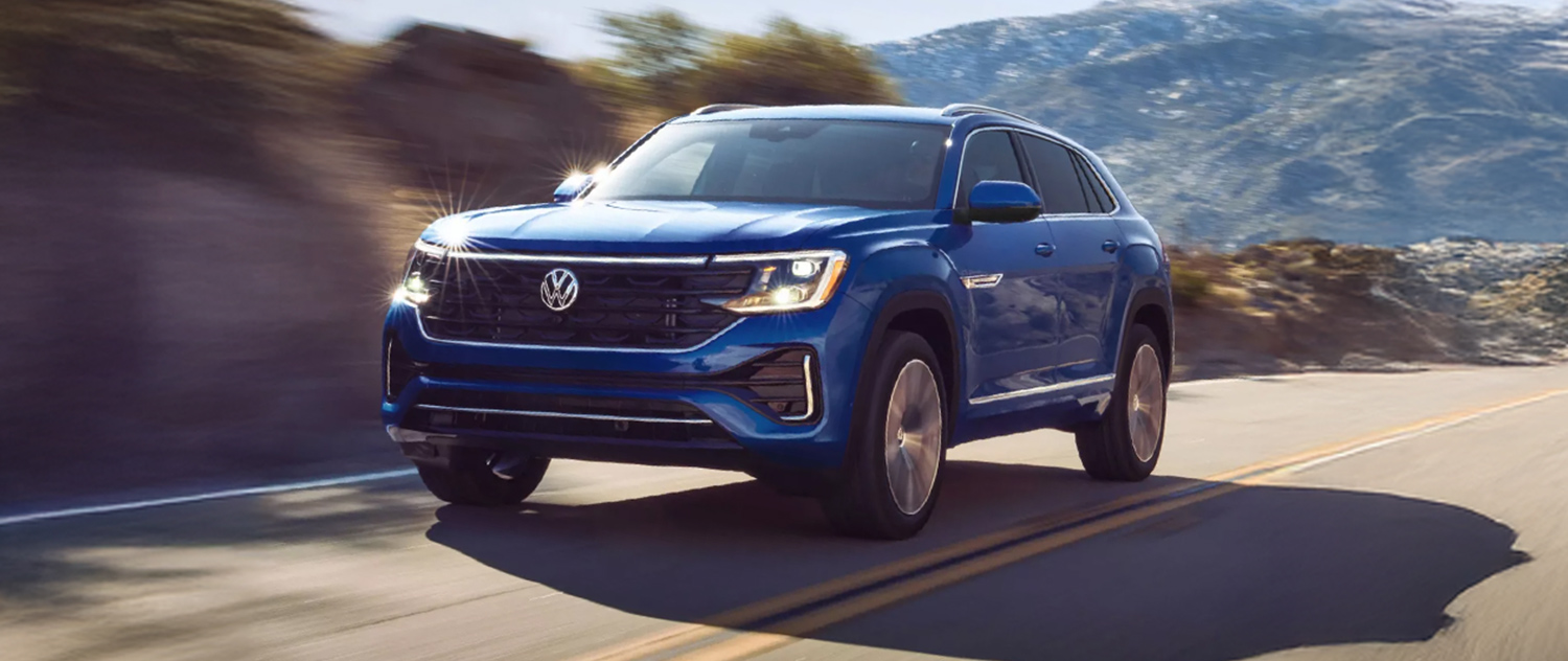 VW Atlas Cross Sport driving down a scenic road