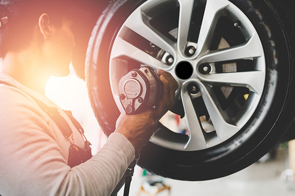 technician working on tire after brake repair