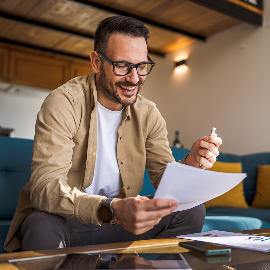 happy person looking at tax document