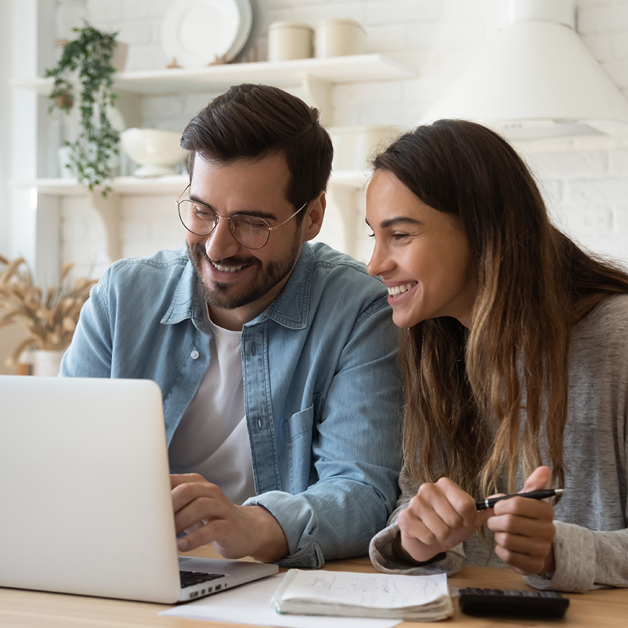 happy couple reviewing their taxes