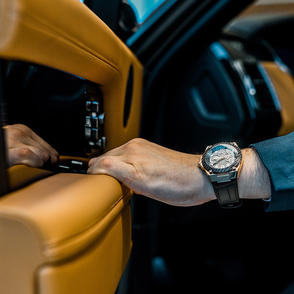 Up close shot of person with watch closing luxury vehicle door