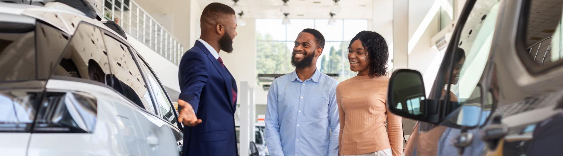 couple buying new car at dealership