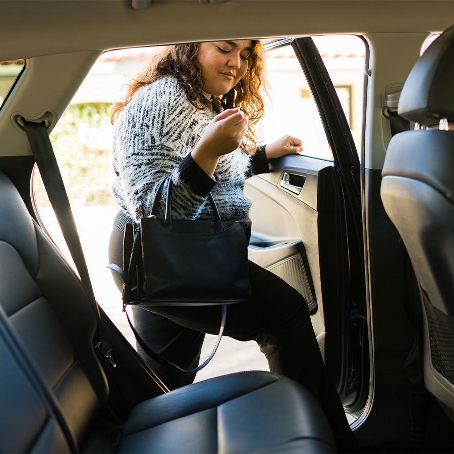 woman requesting a rideshare service car