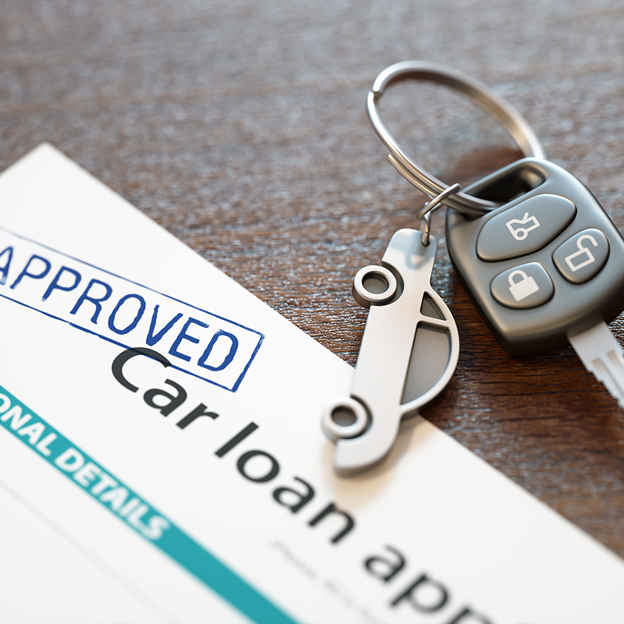 close up of car keys with an approved car loan application