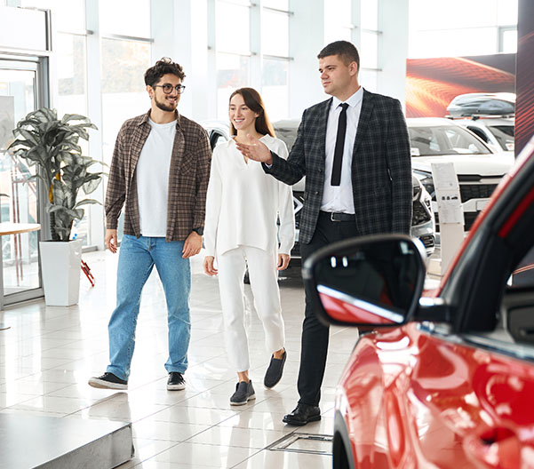 People being shown around new dealership.