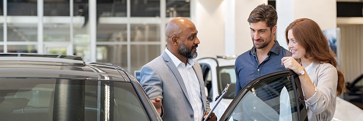 Customers being shown vehicles in dealership showroom