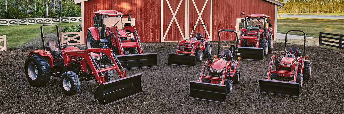 Exterior shot of tractors on gravel.